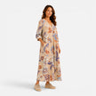 Women's boho floral print V-neck maxi dress by FJØRNA, flowing fabric with a V-neckline and vibrant floral pattern.