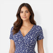 Women's floral V-neck midi dress by FJØRNA, elegant summer dress perfect for weddings and special occasions, shown in the image.
