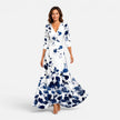 Women’s floral wrap maxi dress with elegant V-neck silhouette by FJØRNA, featuring a flowing design and vibrant floral pattern.