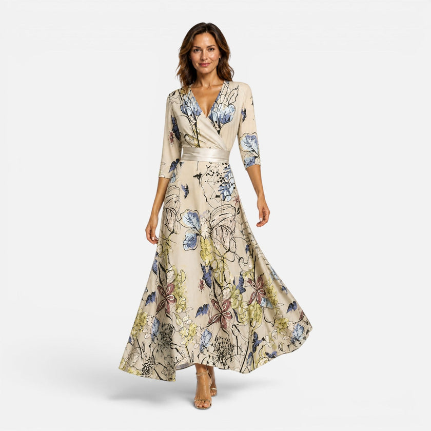 Women wearing FJØRNA floral wrap maxi dress with V-neck, showcasing elegant silhouette and vibrant floral pattern.
