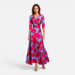 Women’s floral wrap maxi dress with an elegant V-neck silhouette by FJØRNA, shown on a model in a stylish outdoor setting.