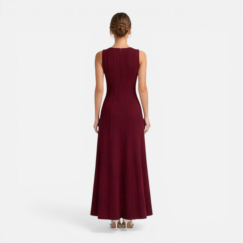 Women’s sleeveless formal maxi dress by FJØRNA with pleated design, suitable for wedding guests and special occasions.
