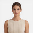 FJØRNA women's sleeveless formal maxi dress with pleated design, ideal for wedding guest attire, shown in a stylish silhouette.