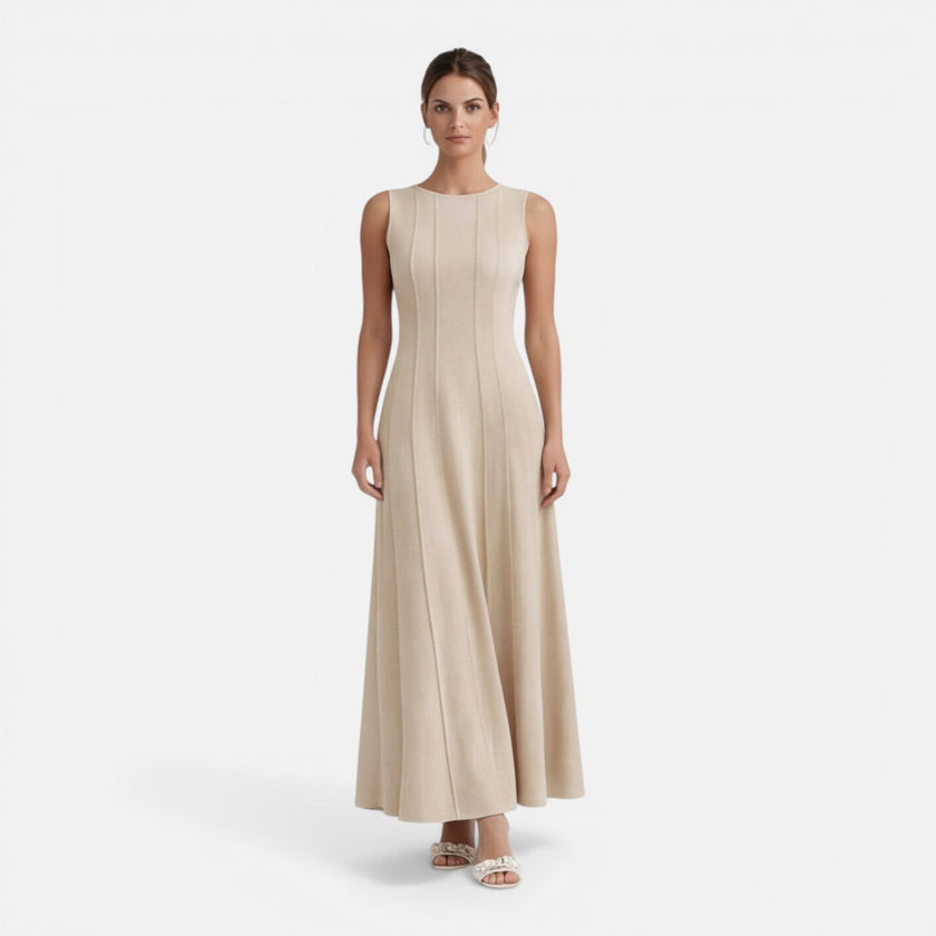 Women's sleeveless formal maxi dress with pleats by FJØRNA, perfect for wedding guest attire, shown in a stylish elegant design.