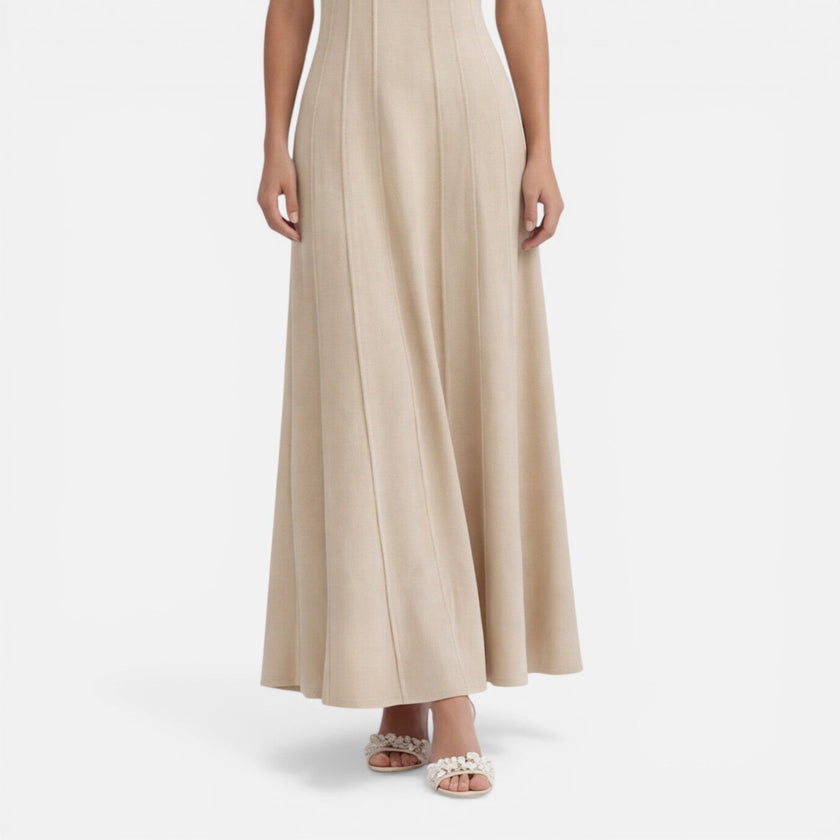 Women’s sleeveless formal maxi dress by FJØRNA with pleated design, perfect for wedding guest or elegant occasions.
