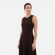 Women’s sleeveless pleated formal maxi dress by FJØRNA, perfect for wedding guests, shown in a stylish, flowing design.