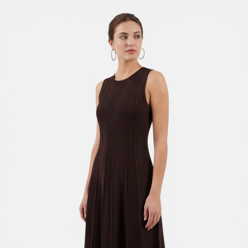 Women’s sleeveless pleated formal maxi dress by FJØRNA, perfect for wedding guests, shown in a stylish, flowing design.