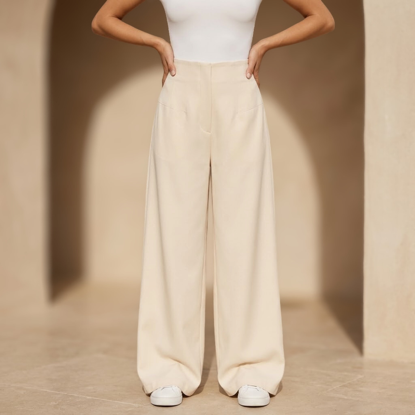 Women’s high-waisted tailored wide-leg trousers by FJØRNA displayed on a model, showcasing the chic, structured fit and fabric details.