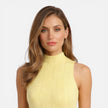 Women's slim fit knit mini dress from FJØRNA featuring sleeveless design and mock neck, shown on a model.