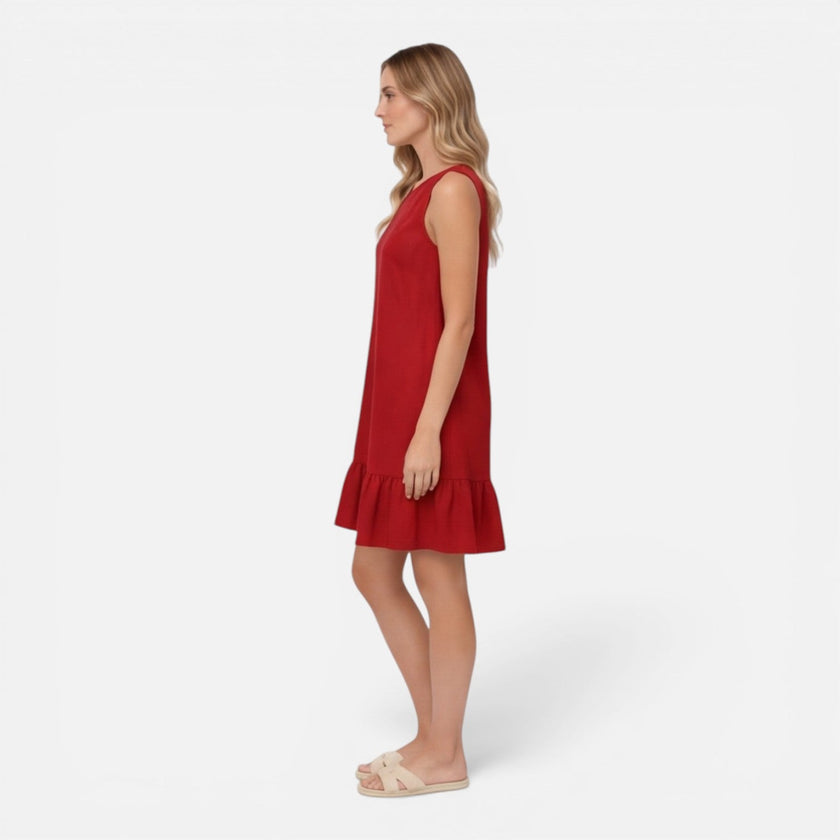 Women’s lightweight summer dress by FJØRNA featuring a sleeveless A-line design with ruffle hem, perfect for warm weather.