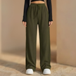Women’s wide-leg pleated trousers with elastic waist by FJØRNA, showcasing relaxed fit and stylish design.
