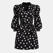 Women’s polka dot jumpsuit by FJØRNA featuring a V-neckline and puff sleeves, perfect for casual or semi-formal wear.