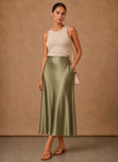 Women's satin midi skirt by FJØRNA, elegant A-line flowing dress with smooth fabric and stylish design.