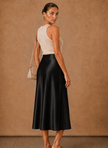 Women's satin midi skirt by FJØRNA featuring an elegant A-line flowing design, showcased on a model.