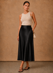 Women’s satin midi skirt by FJØRNA featuring an elegant A-line flowing design and soft, shiny fabric.