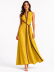 Women’s sleeveless midi dress by FJØRNA with stand collar and relaxed fit, shown on a model in a stylish outdoor setting.