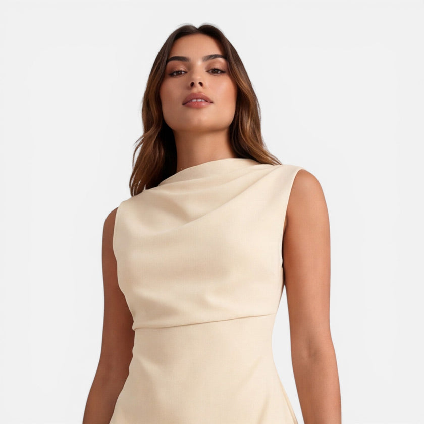 Elegant women's sleeveless mini dress by FJØRNA with a draped neckline, perfect for stylish occasions or wedding guest attire.