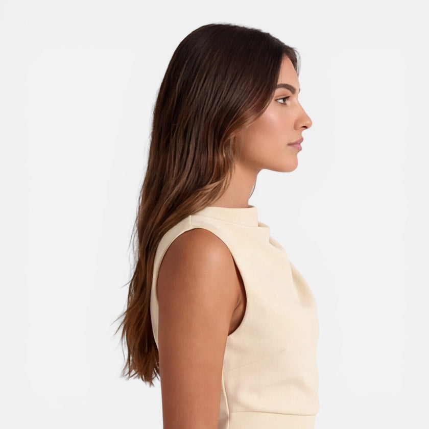 Women’s sleeveless mini dress by FJØRNA featuring an elegant draped neckline, perfect for special occasions and wedding guests.