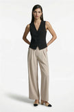 Women's slim fit black sleeveless waistcoat by FJØRNA, full-body shot showcasing tailored layering style.