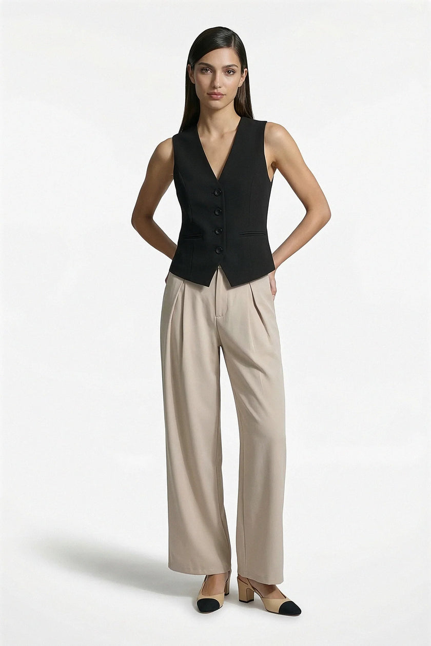 Women's slim fit black sleeveless waistcoat by FJØRNA, full-body shot showcasing tailored layering style.