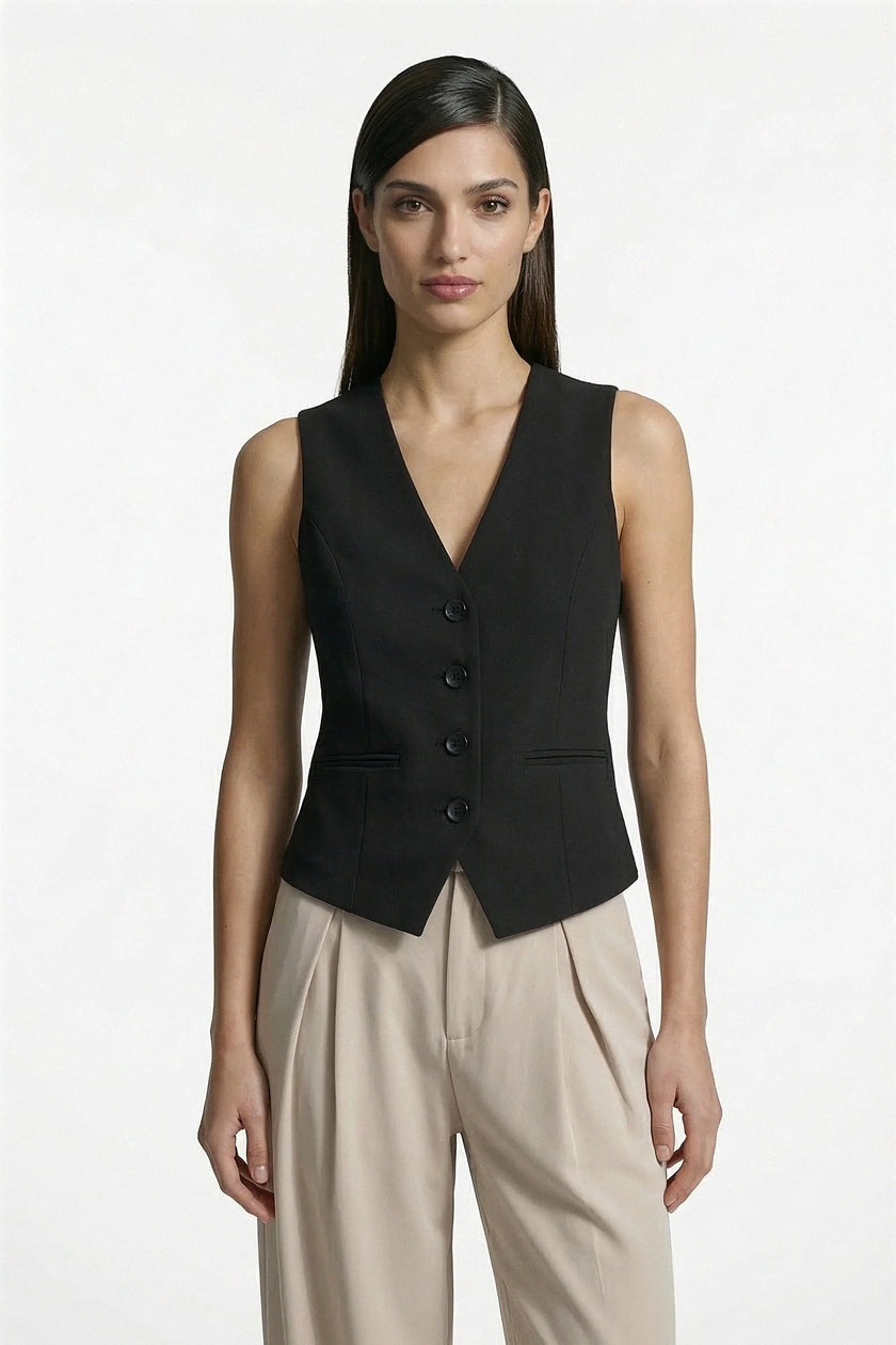 Black women's slim fit sleeveless waistcoat by FJØRNA, tailored for a sleek, layered look with a medium shot view.