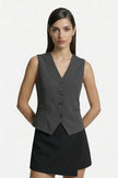 Dark gray women's sleeveless slim fit waistcoat by FJØRNA, tailored layering piece with a sleek, fitted design.