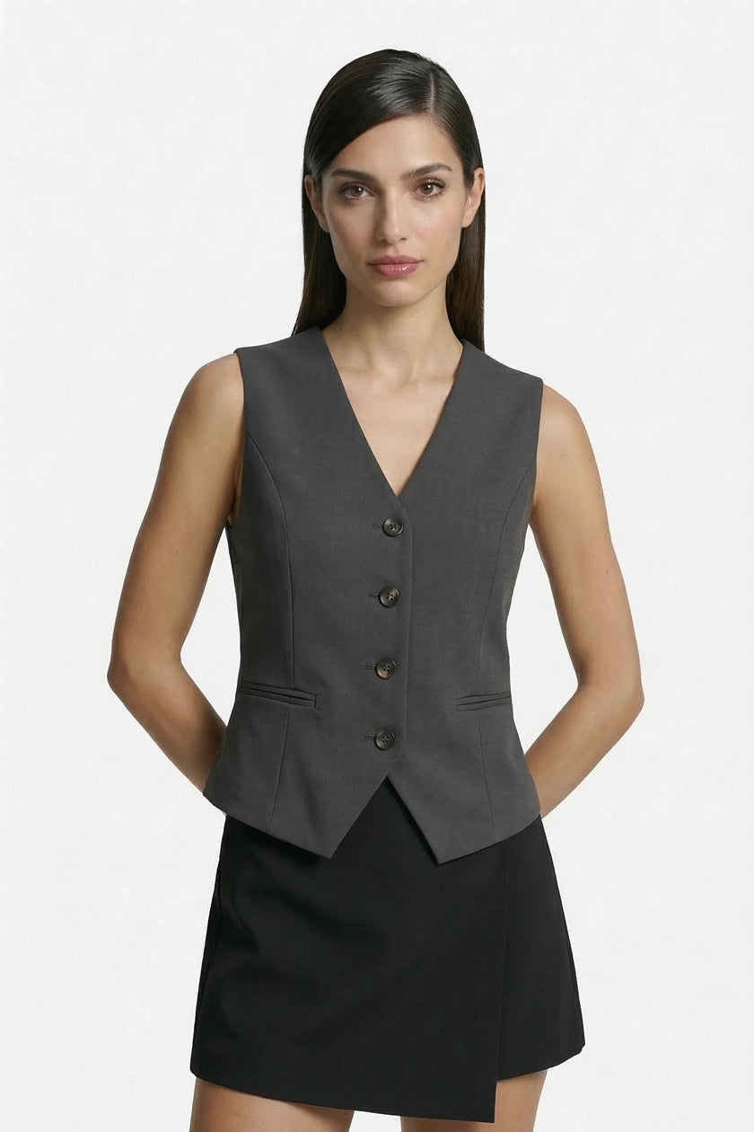 Dark gray women's sleeveless slim fit waistcoat by FJØRNA, tailored layering piece with a sleek, fitted design.