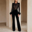 Women wearing a black lace sequin jumpsuit by FJØRNA, featuring stylish pants and a fitted silhouette for elegant occasions.