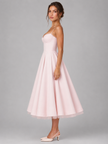 FJØRNA women's corset midi dress with full skirt, elegant occasion style, showcased on a model in a formal setting.
