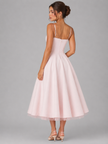 FJØRNA women's corset midi dress with full skirt, elegant occasion style, shown in a flattering fit and flowing design.