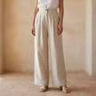 Women’s high-waisted linen wide-leg trousers by FJØRNA, tailored pants with a relaxed fit and elegant style.