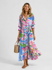 Women’s floral print maxi shirt dress by FJØRNA featuring a button front and relaxed, flattering fit.