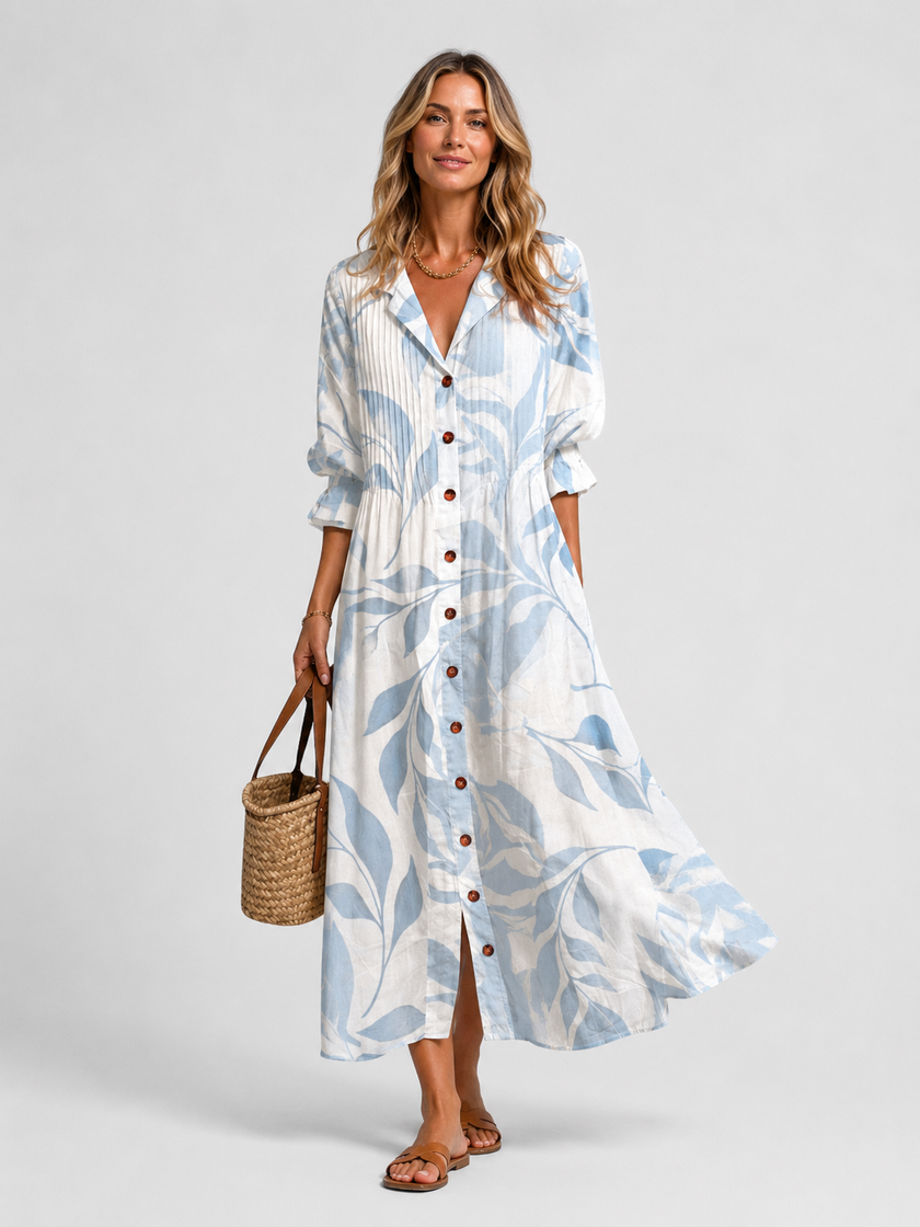 Women's floral print maxi shirt dress with button front by FJØRNA, featuring a relaxed fit and vibrant floral patterns.
