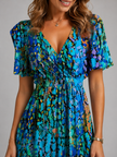 Women’s floral V-neck midi dress with flutter sleeves by FJØRNA, featuring a flowing silhouette and vibrant summer floral pattern.