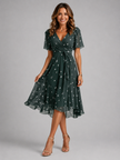 Women's floral V-neck midi dress with flutter sleeves by FJØRNA, featuring a flowing silhouette and feminine summer style.