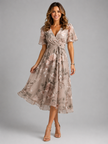 Women’s floral V-neck midi dress with flutter sleeves by FJØRNA, featuring a flowing silhouette and vibrant summer floral print.