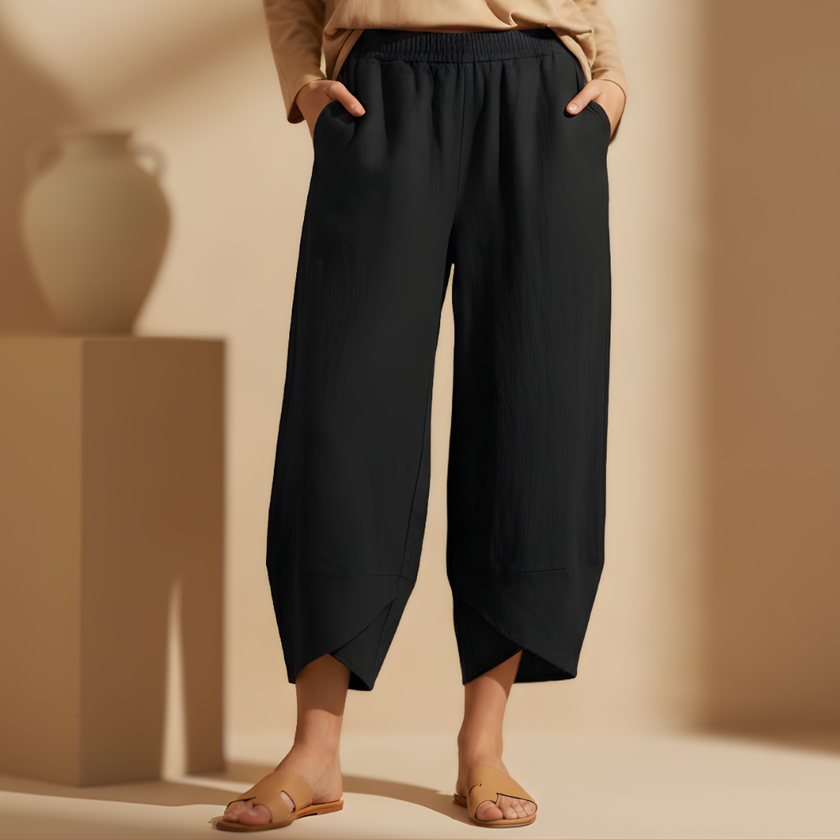 Women’s wide-leg cotton trousers with elastic waist from FJØRNA, featuring a loose fit and relaxed style.