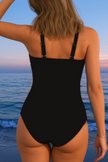 Women's FJØRNA tummy control one-piece printed swimsuit with a vibrant floral pattern and supportive design for a flattering fit.
