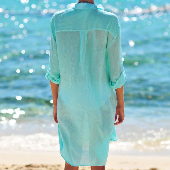 Women's FJØRNA button-down cover-up mini dress with chest pockets, lightweight and casual for beach or poolside wear.