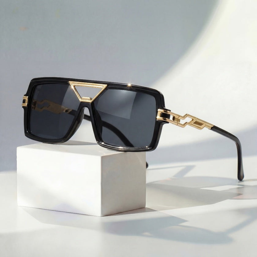 Women's retro square sunglasses by FJØRNA with gold chain link detail and UV protection, stylish eyewear for sunny days.