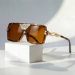Women's retro square sunglasses with gold chain link accents and UV protection, stylish FJØRNA eyewear.
