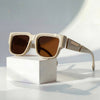 Women's square FJØRNA sunglasses with thick frames and wide temples, showcasing stylish eye protection and modern eyewear design.