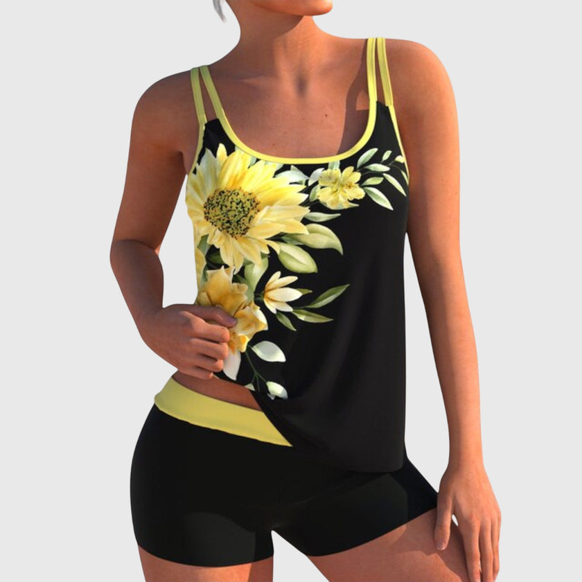 Women's floral tankini set by FJØRNA with contrast trim and matching boy shorts, featuring colorful floral placement print.