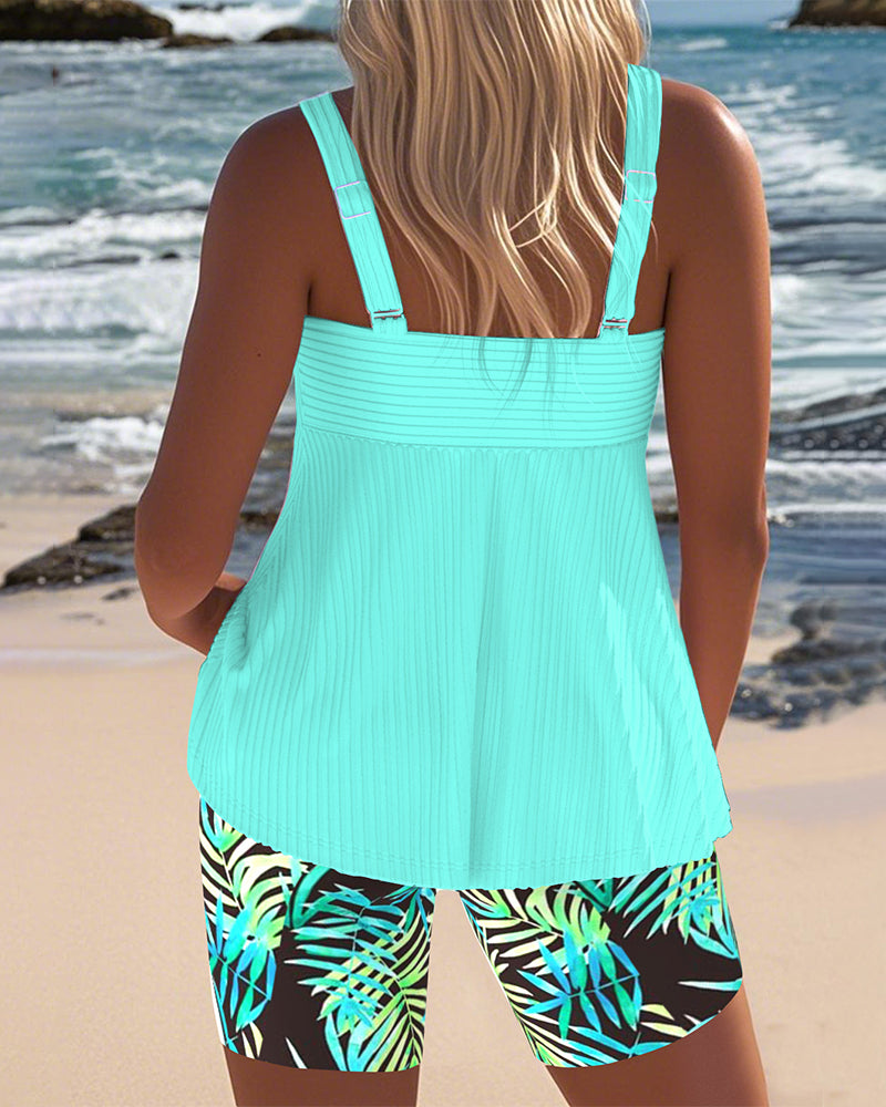 Women's FJØRNA tummy control tankini with printed bottoms, featuring a supportive top and vibrant printed swimwear bottoms.
