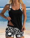 Women's FJØRNA two-piece tankini swimsuit with floral swim shorts, featuring a tankini top and colorful floral design.
