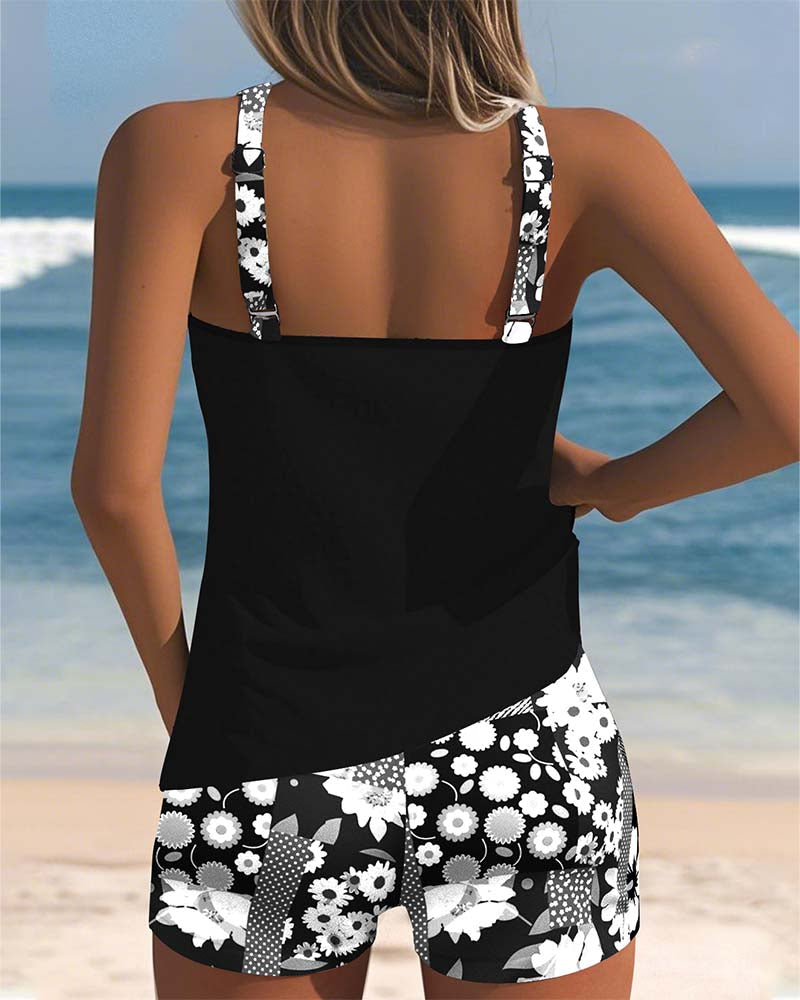 Women's two-piece tankini swimsuit by FJØRNA with floral swim shorts, featuring a supportive tankini top and vibrant floral pattern.