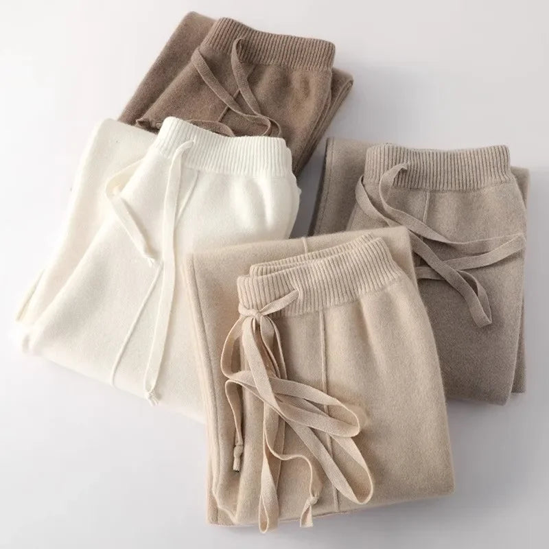 White woolen women's joggers by FJØRNA featuring knitted, wide-leg design for fall and winter outdoor wear.