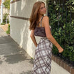 FJØRNA Y2K plaid slip midi dress featuring a fitted bodice and flowing skirt, perfect for day to night fashion.