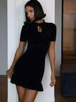 FJØRNA Y2K ribbed mini dress featuring a fitted silhouette with a high neckline and short sleeves, styled for a trendy look.