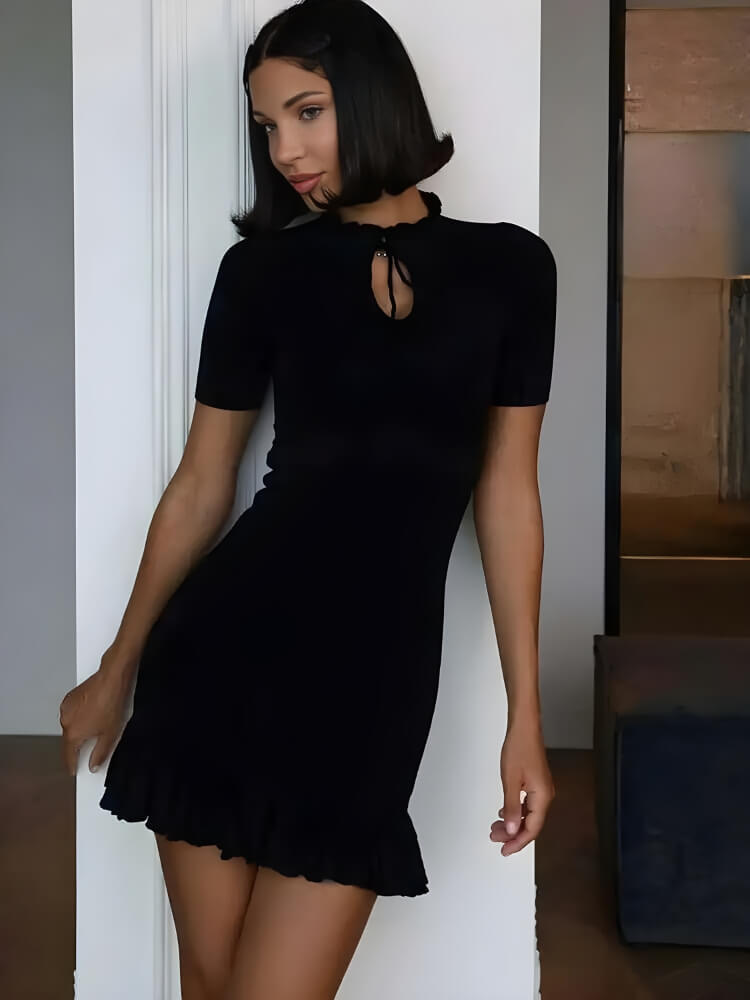 FJØRNA Y2K ribbed mini dress featuring a fitted silhouette with a high neckline and short sleeves, styled for a trendy look.